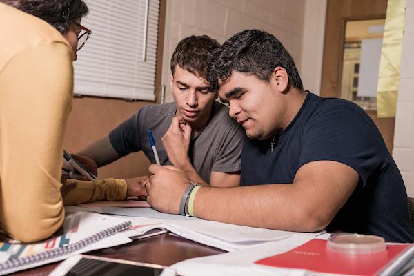 A group of students working at their desks on a project